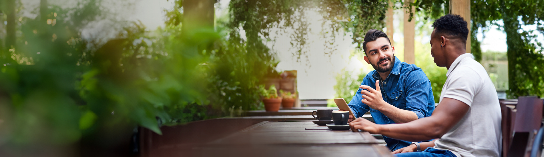 two men chatting over coffee